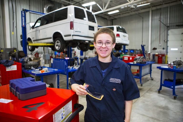 An automotive technology student learning to repair SUVs
