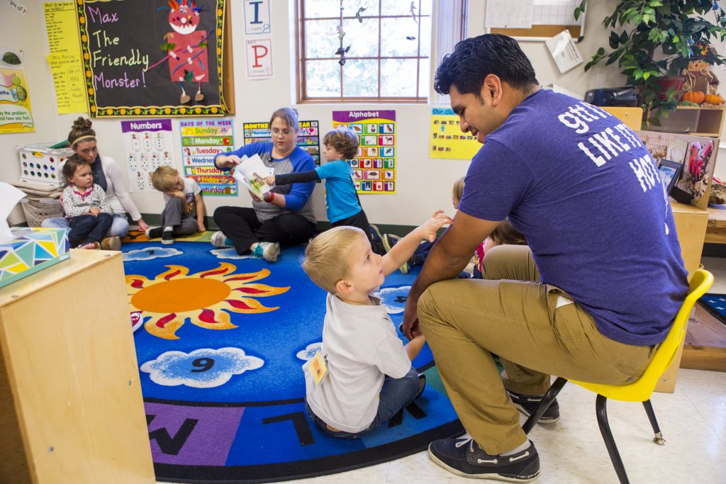 Early childhood development students teaching children in a classroom