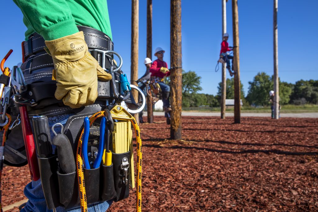 Electrical distribution systems students practicing working on a utility pole